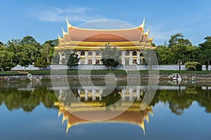 A white and gold church reflection with the water surface in WAT BOONYAWAD at Chon Buri, Thailand