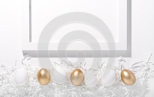 White and gold Easter eggs on a white background