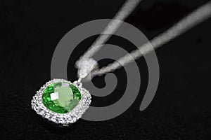 White gold necklace Set with emerald surrounded by diamonds