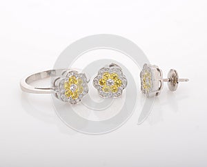 White gold ring and earrings, with diamonds on white background