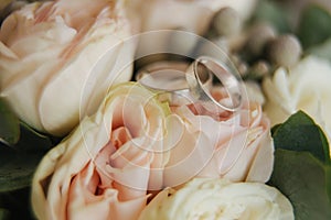 White gold rings on wedding bouquet. flowers