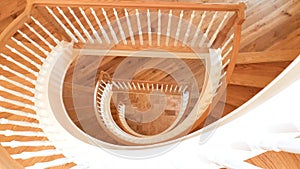 White and Golden Brown Wooden Spiral Staircase Looking Down