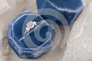 White golden wedding ring with diamonds in blue vintage velvet r