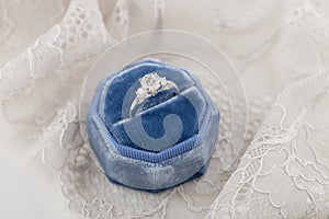 White golden wedding ring with diamonds in blue vintage velvet r