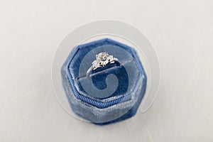 White golden wedding ring with diamonds in blue vintage velvet r