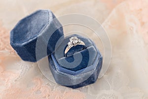 White golden wedding ring with diamonds in blue vintage velvet r