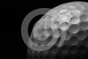 White golf ball on black background.