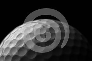 White golf ball on black background.