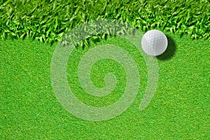 White golf ball on green grass background)