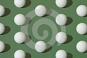 White golf ball on a green pastel background. Minimal pattern photo