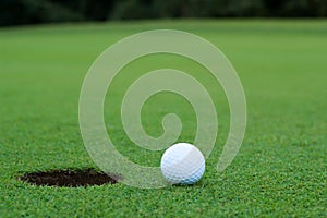 White golf ball on putting green photo