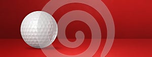 White golf ball on a red studio banner