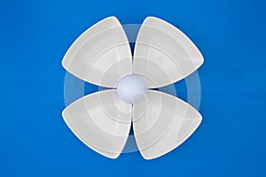 White golf ball on the triangular ceramic bowls
