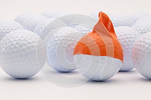 White golf balls with funny cap on the white background.