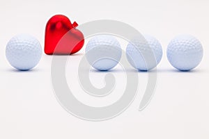 White golf balls and red heart