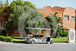 White golf car with back seat on resort.