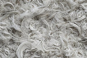 White goose feathers and fluff from pillows texture background