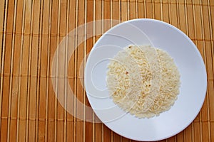 White grain rice on a white plate.