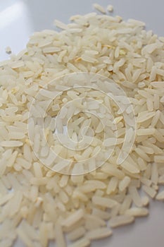 White grain rice on a white plate.