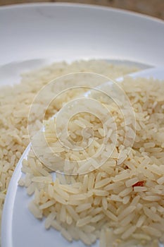 White grain rice on a white plate.