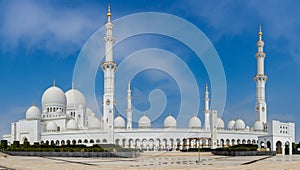 White Grand Mosque against blue sky, also called Sheikh Zayed BinSultan Nahyan Mosque, inspired by Persian, Mughal and Moorish