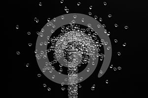 White granules of rubber, polypropylene or polyamide on a black background with tube.
