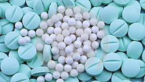 White granules are scattered on round bright green antibiotics. Rotation