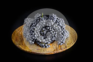 White grapes on wooden plate