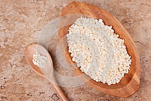 White grated corn kernels in wooden bowl