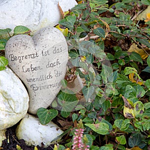 White grave ornament with heart and german words