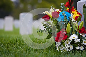 White gravestones and flowers at cemetary for memorial day
