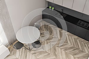 White and gray kitchen with round table, top view