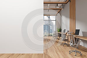 White and gray open space office interior with blank wall