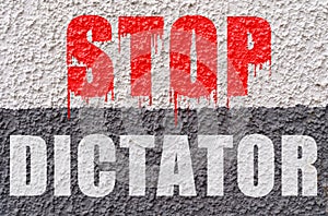 On the white-gray surface of the wall is the inscription - Stop dictator