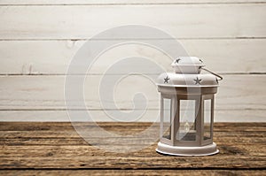 White or gray vintage lamps, candlesticks stand on a wooden table.