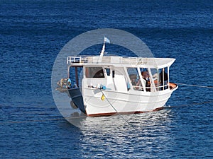 White Greek Caique Anchored in Calm Sea Water, Greece