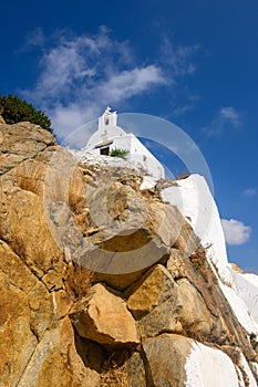 White Greek chapel on the top of hill.