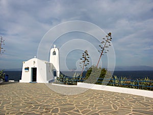 White greek chappel with high agave plant