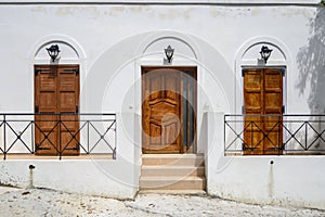 White Greek house with brown doors