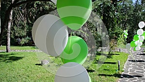 White and green balloons on a holiday