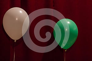 White and green balloons on a red background. For decoration design of the holiday.