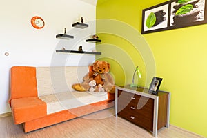 White and green bedroom with orange sofa