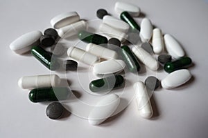 White, green and black tablets, caplets and capsules