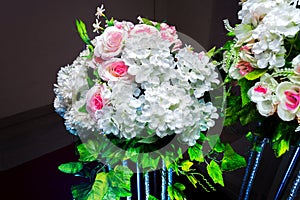 White and green color based artificial plastic flowers a bouquet.