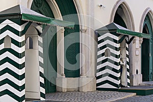 White and green facade of the Republican National Guard Museum with guardsmen on duty photo