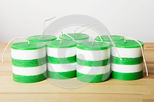 White and green striped cylindrical handmade candles