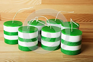 White and green striped cylindrical handmade candles