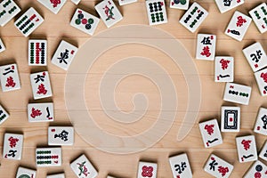 White-green tiles for mahjong on a background of light brown wood. Empty space in the center