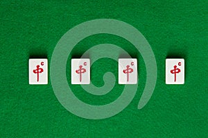 White-green tiles for mahjong on green cloth. 4 dragons