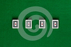 White-green tiles for mahjong on green cloth. 4 dragons